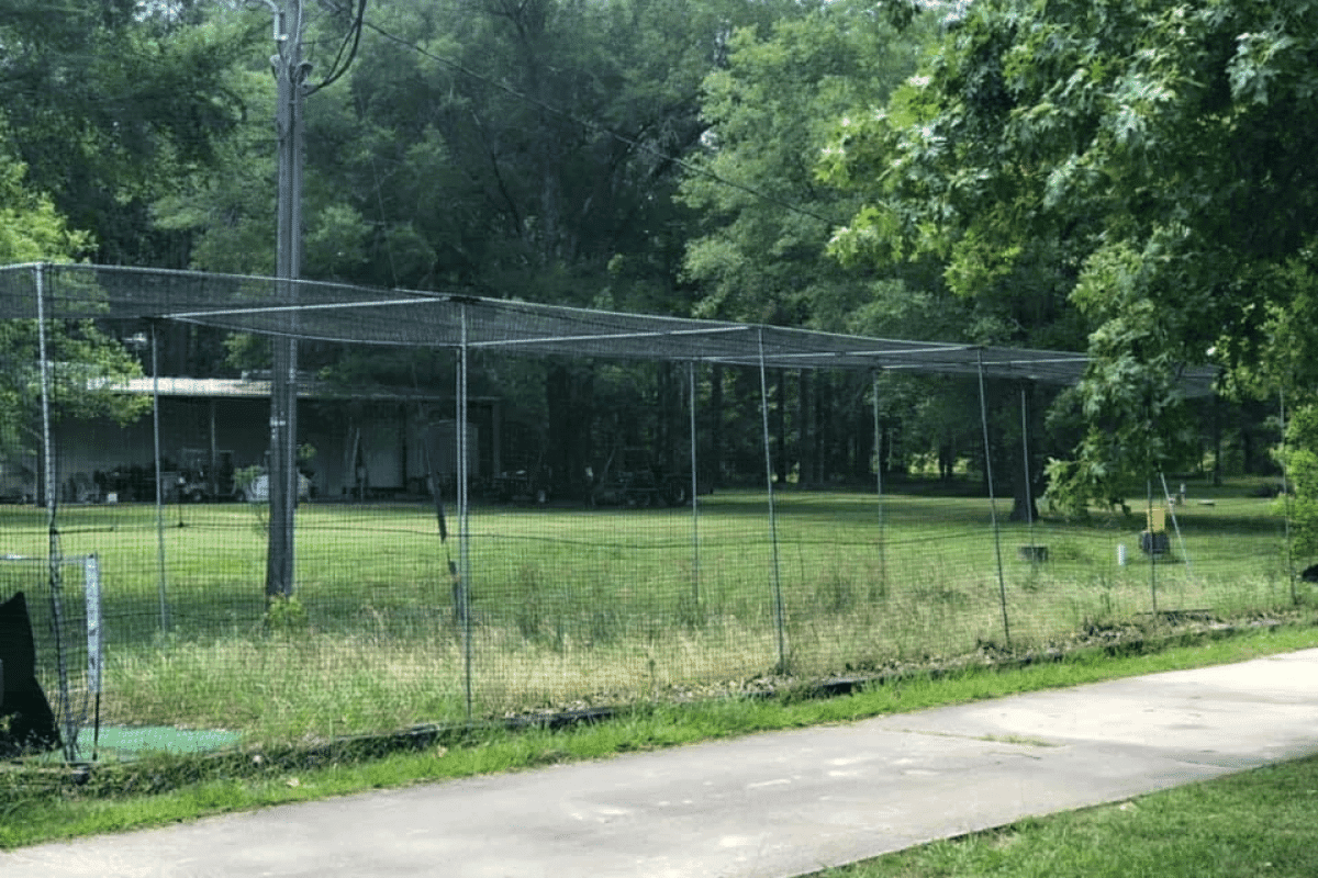 Basic batting cage foundation with ground anchors and simple steel frame