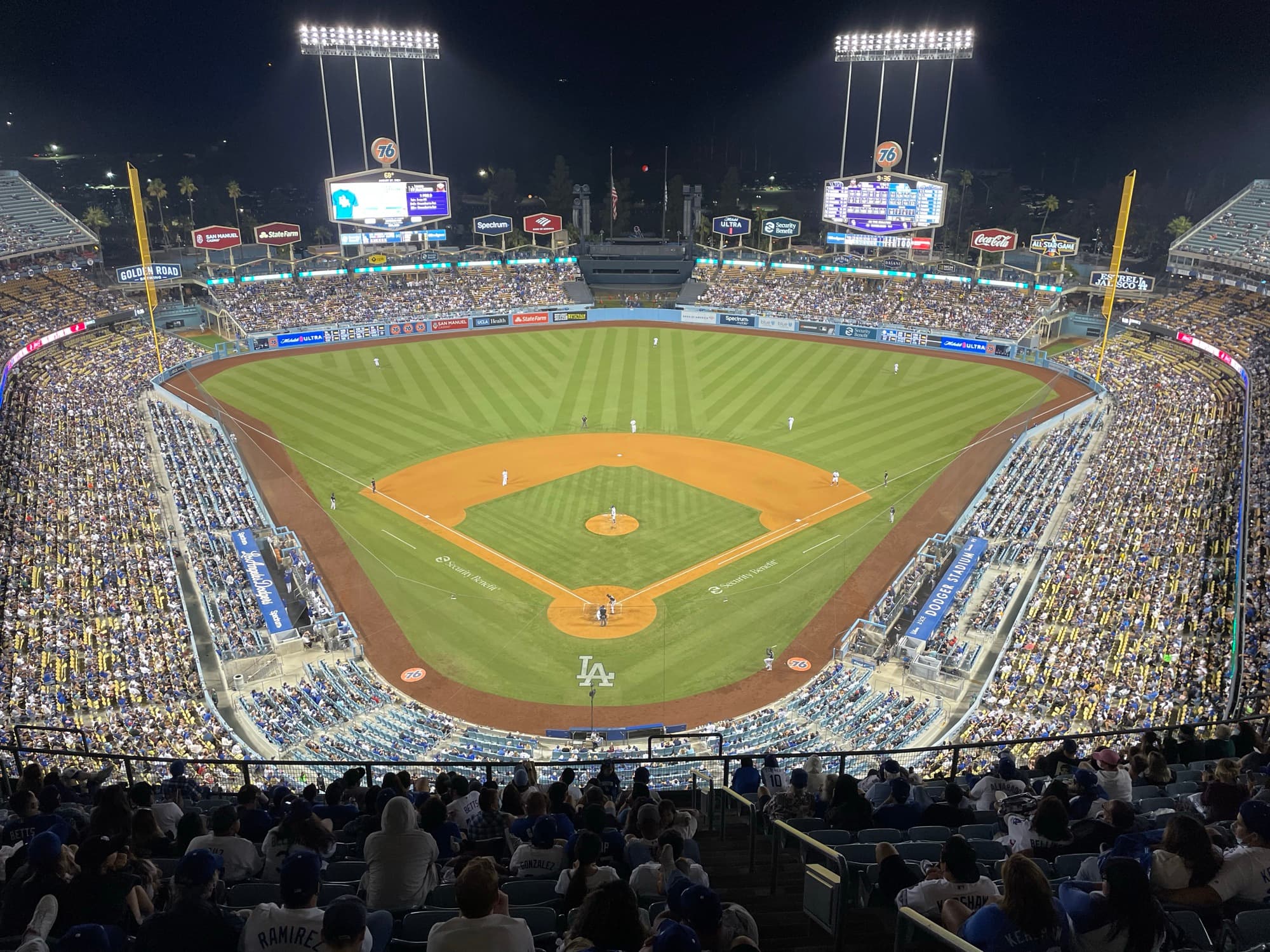 Dodger Stadium at night, with the field lit up and the scoreboards glowing beyond the outfield