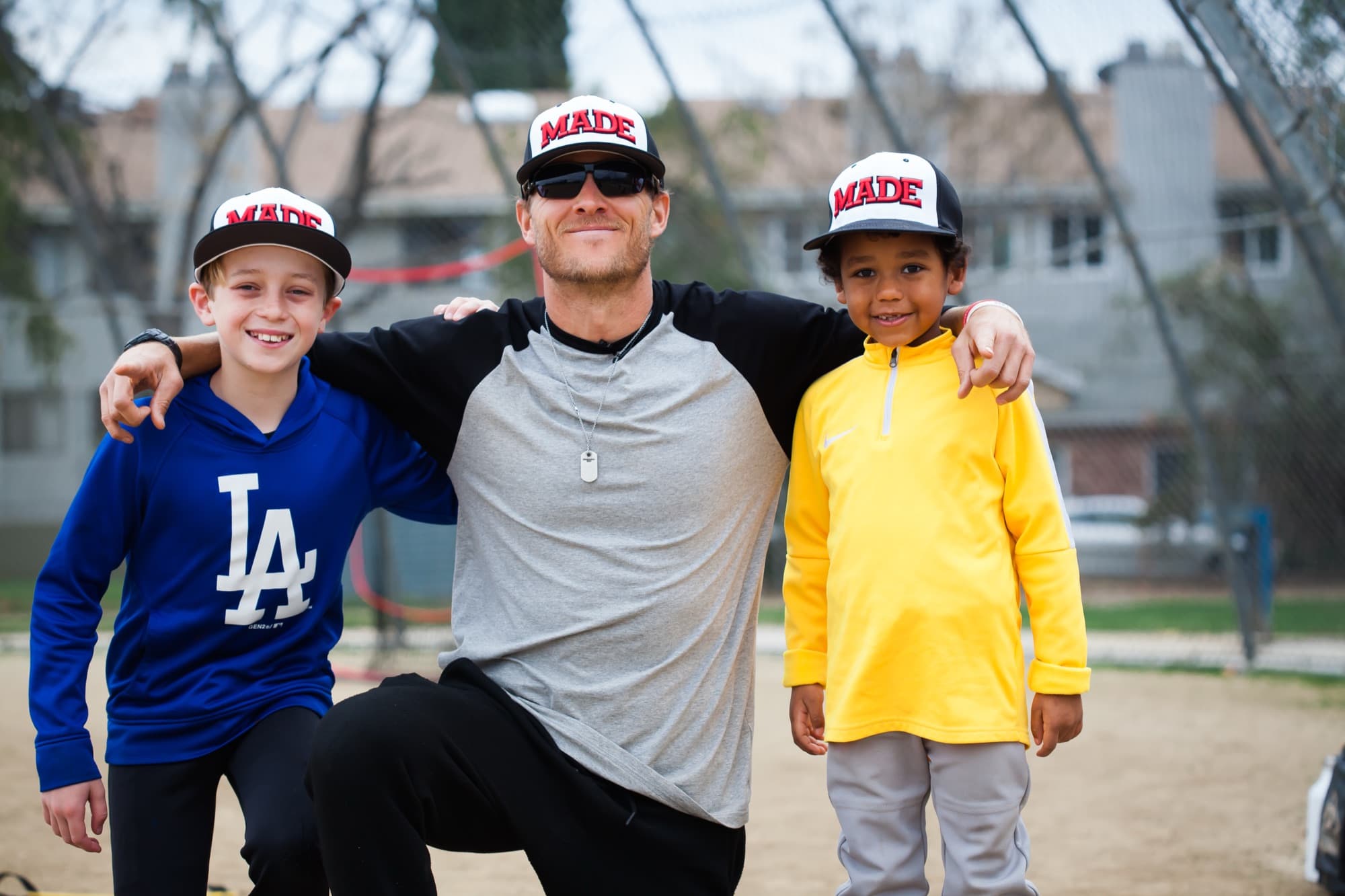 Isaac Hess coaching two players at a MADE Baseball camp
