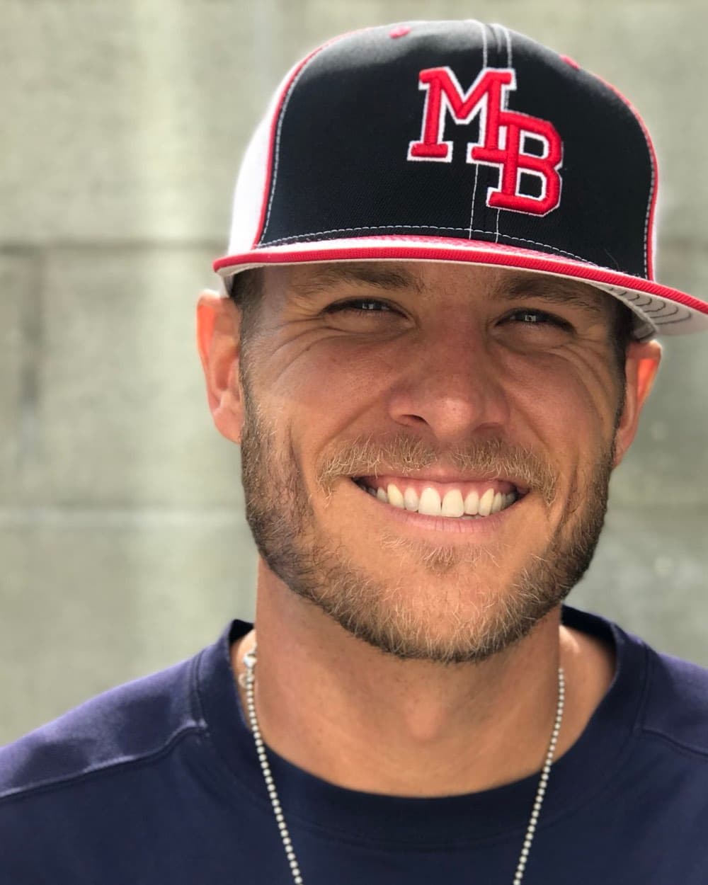 Isaac Hess smiling in a MADE Baseball cap