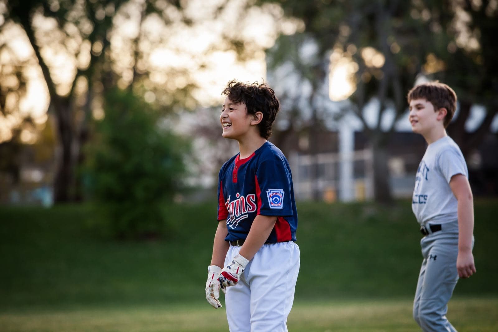 A young player laughing on the field after a good rep
