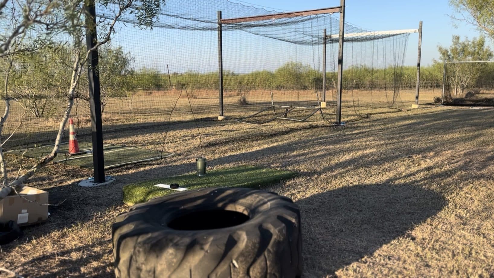 A backyard batting cage set up for hosting