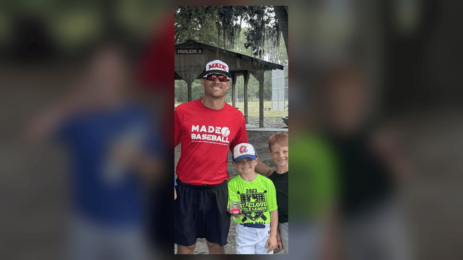 Coach Isaac Hess with two youth baseball players at a MADE Baseball field session