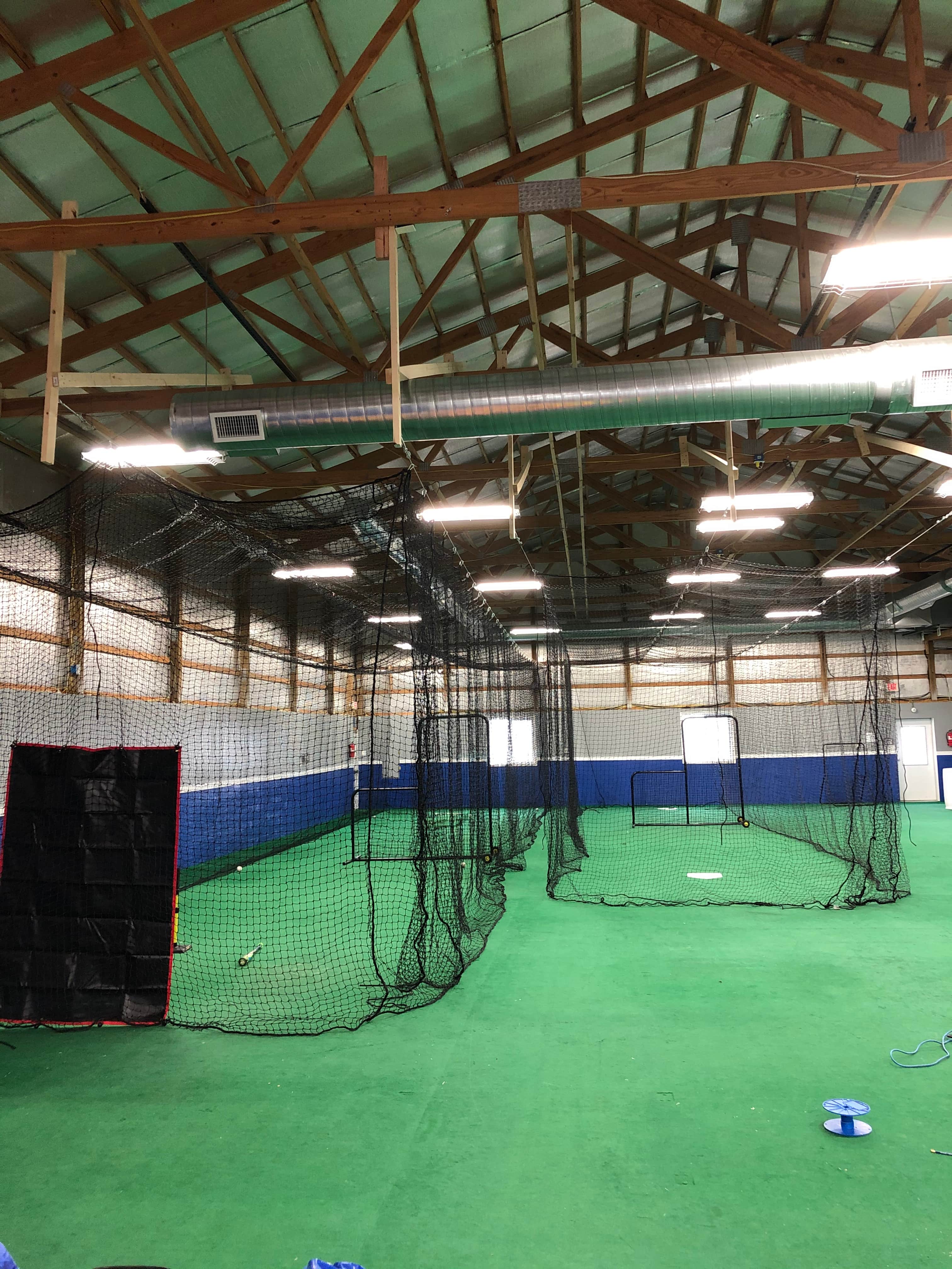 Indoor batting cage with lots of open turf