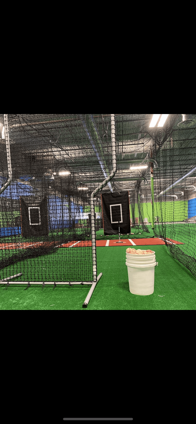 5 indoor batting cages with an open practice space