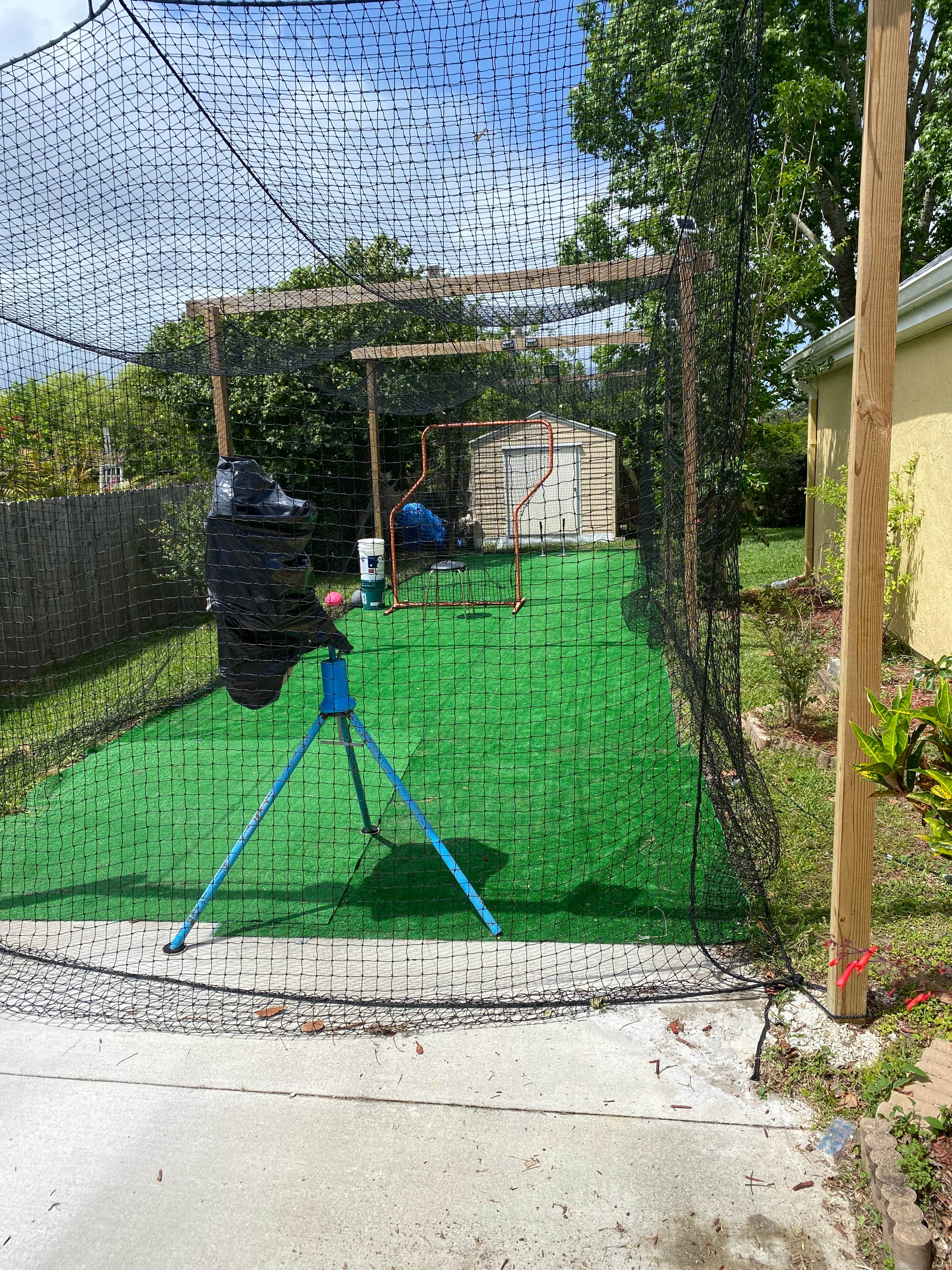 Full length batting cage with pitching machine in Melbourne, FL
