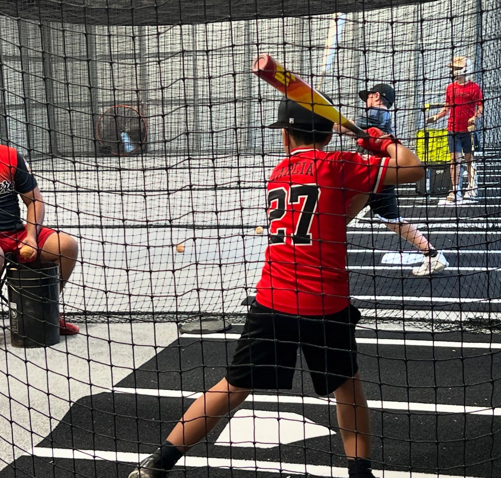 A young player loading up in the cage at Swing Kingz