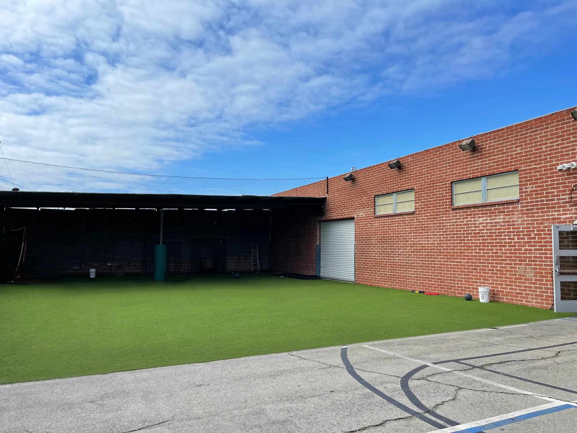 The outdoor turf training area beside the Beach City Baseball Academy building