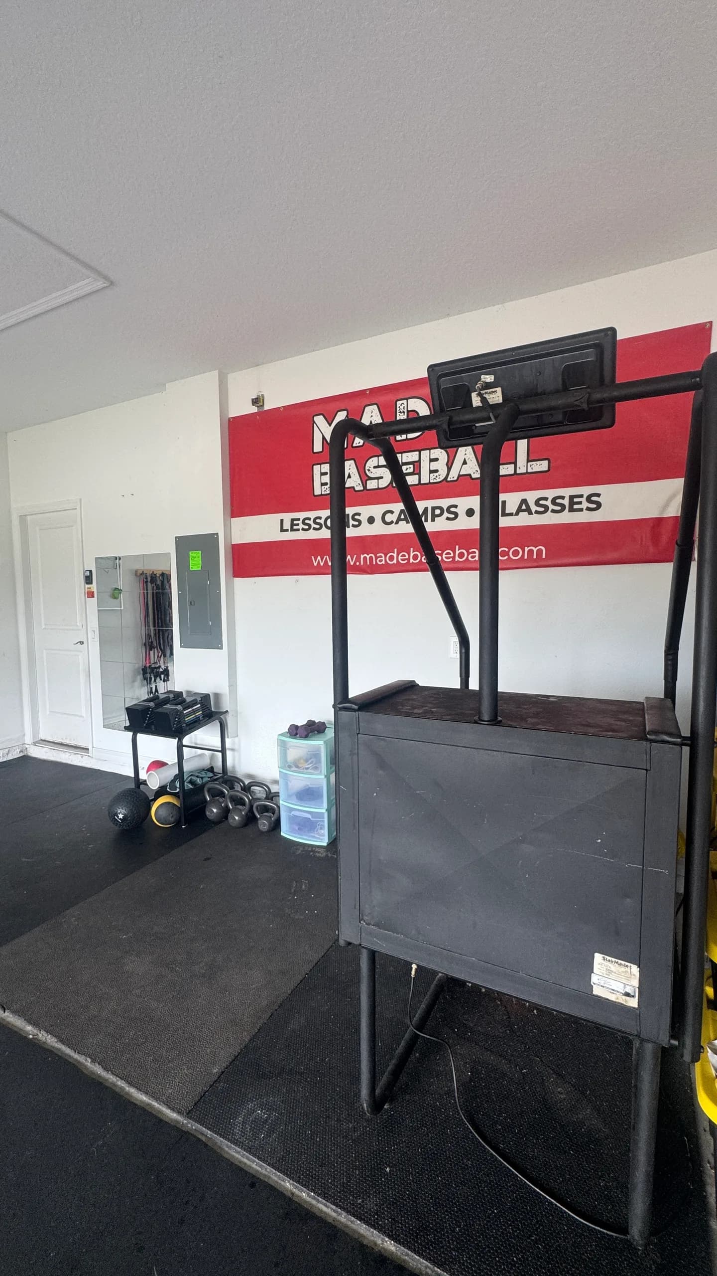 MADE Baseball banner and conditioning equipment inside the Saint Cloud garage facility