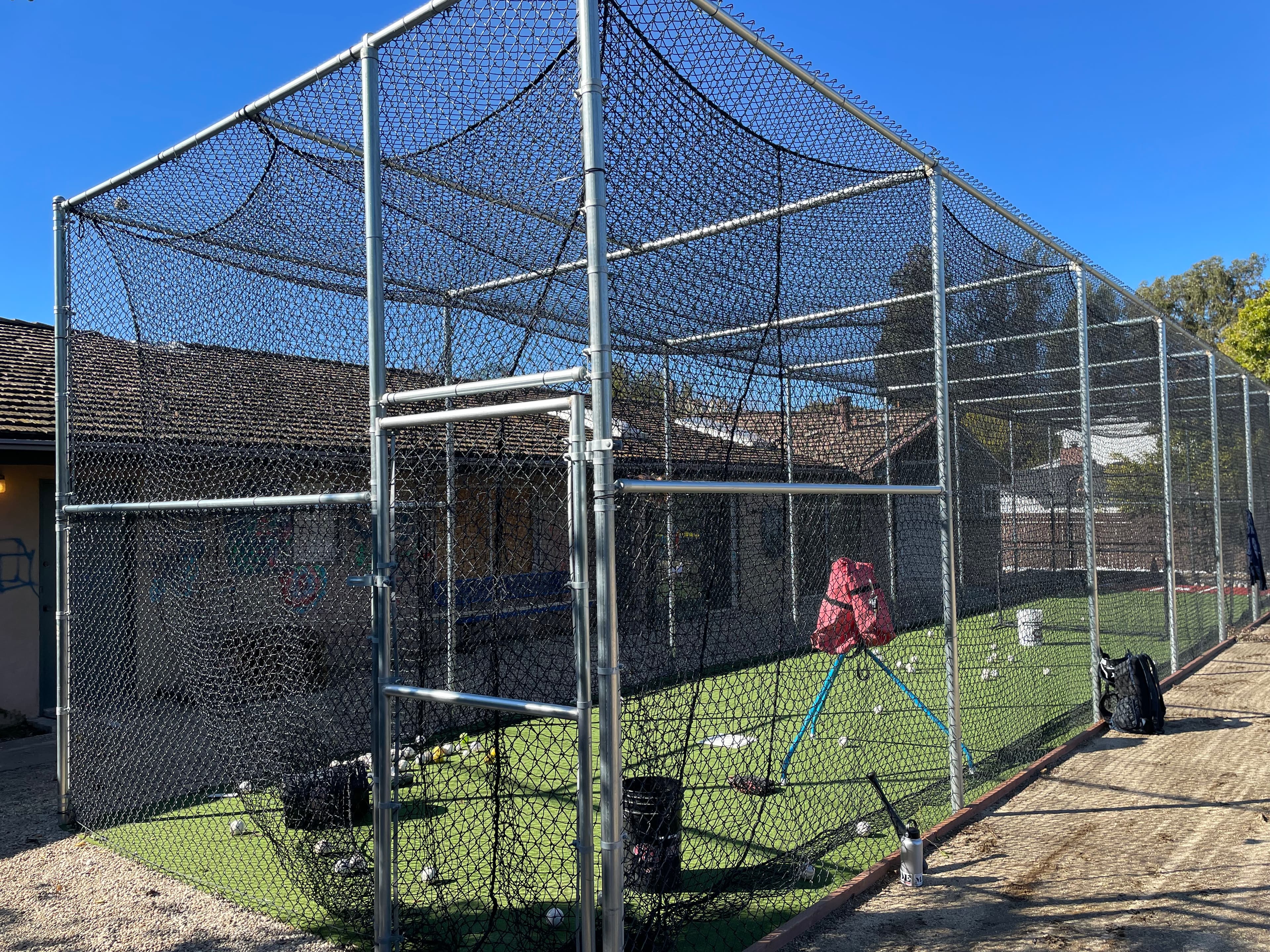One-on-one private batting lesson in a cage