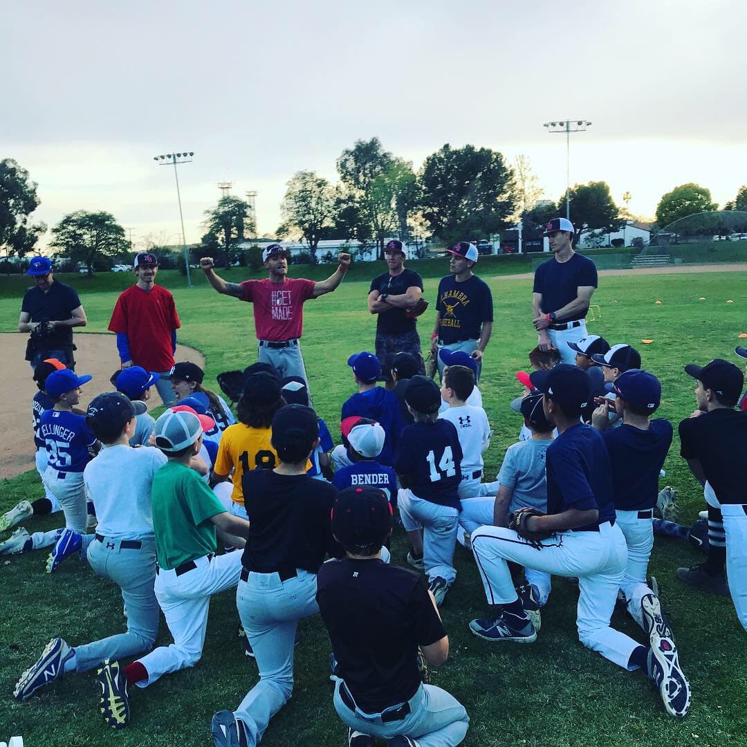 Coach addressing youth baseball players during team practice